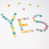 Grimms handcrafted wooden confetti dots in a pastel palette spelling the word YES