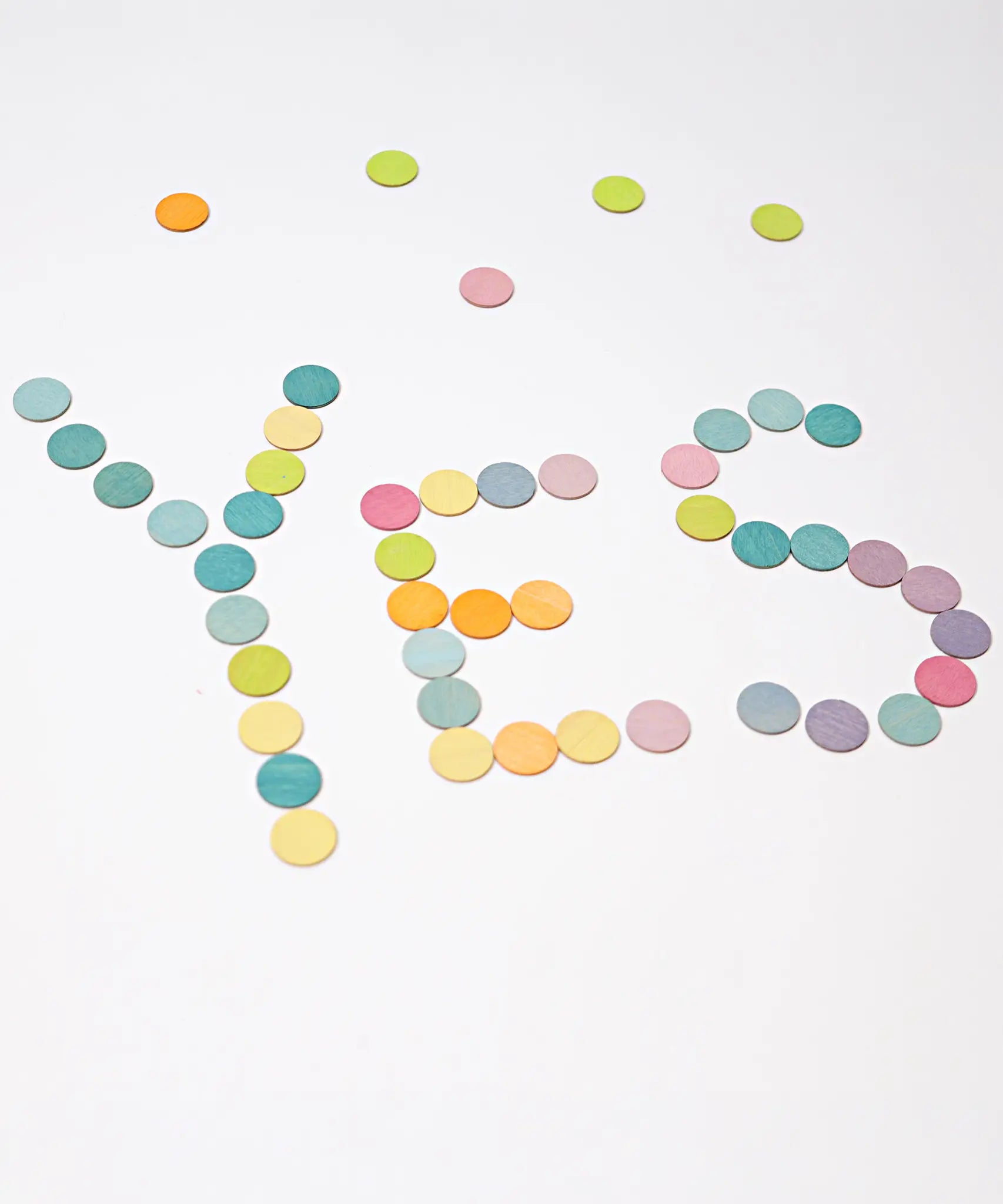 Grimms handcrafted wooden confetti dots in a pastel palette spelling the word YES