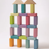 A large building has been made using the Grimms Wooden Pastel Duo Blocks. The roof is made from the natural blocks