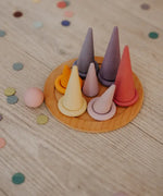 Grimms pastel forest pieces standing on a small plate with matching rings