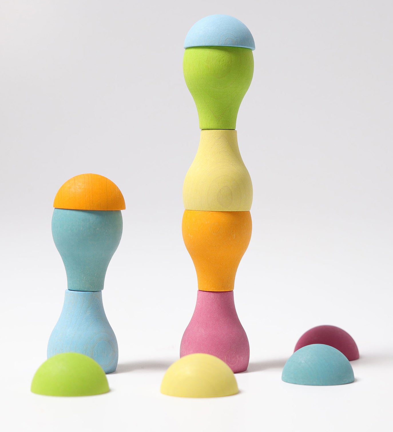 Grimm's Pastel Mushrooms Sorting Game shown with the pieces stacked on top of each other to create little towers.