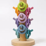 Grimms wooden sorting helper showing pastel palette rings on matching dowels