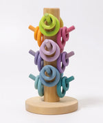 Grimms wooden sorting helper showing pastel palette rings on matching dowels