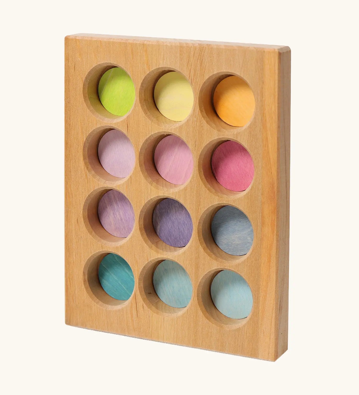 Grimms handcrafted wooden sorting board with 12 round slots in delicate pastel colours, made for sorting games
