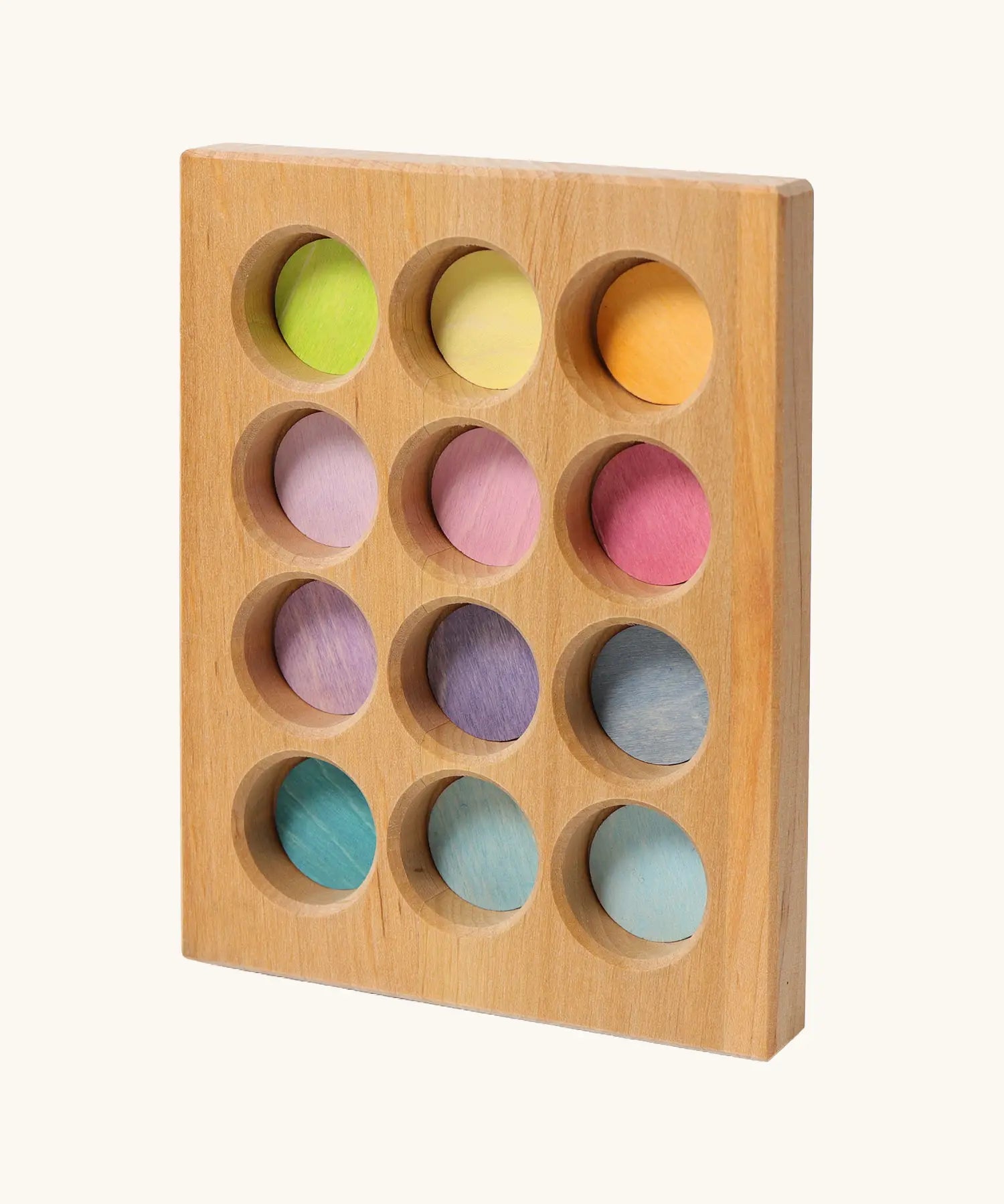 Grimms handcrafted wooden sorting board with 12 round slots in delicate pastel colours, made for sorting games