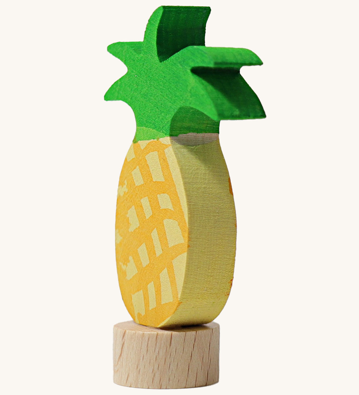 A side view of the Grimms pineapple frog wooden decorative figure showing the thickness of the figure