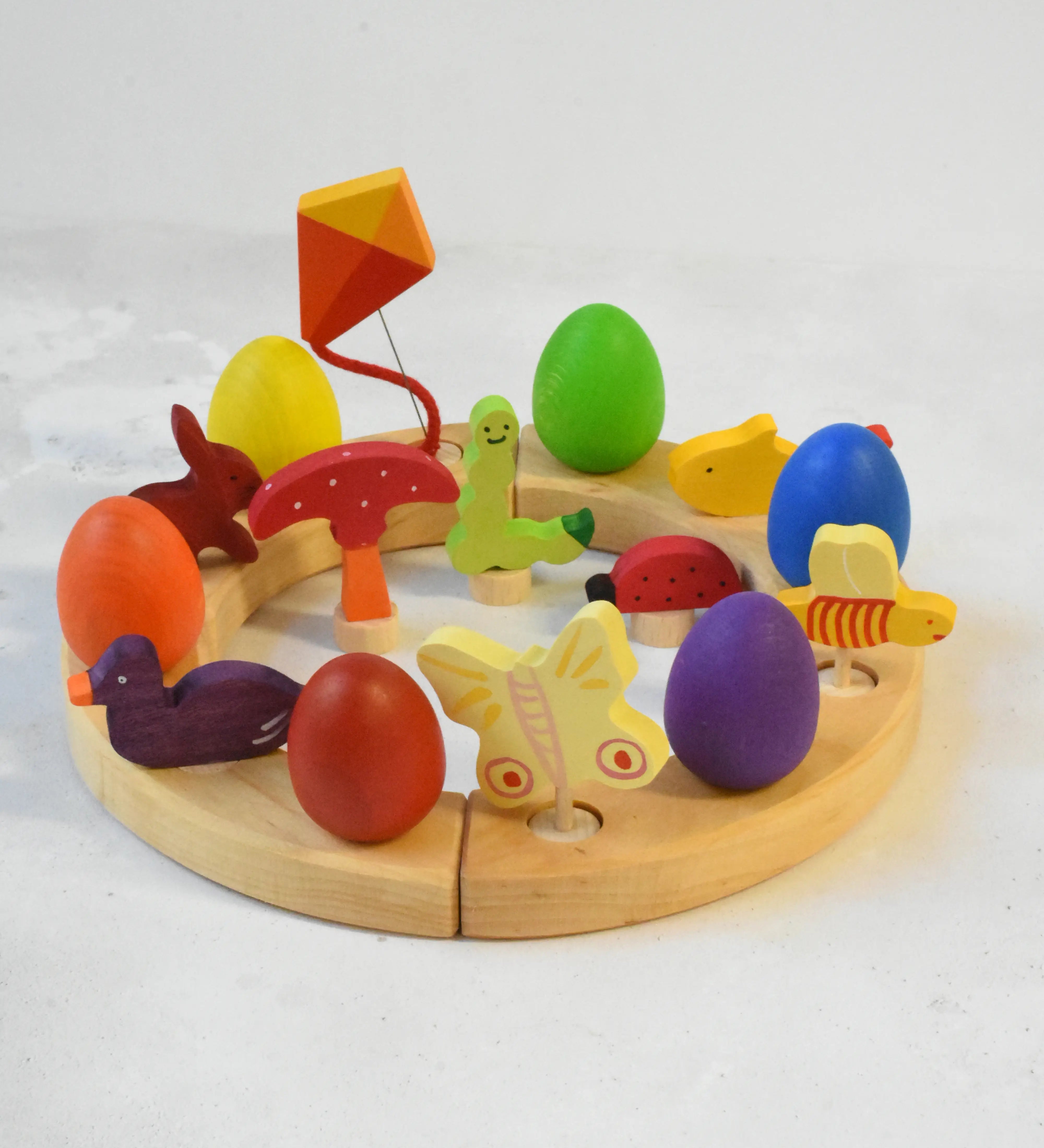 A Grimm's wooden celebration with a rabbit, kit, fish, bee, ladybird, butterfly worm , duck and mushroom decorative figures