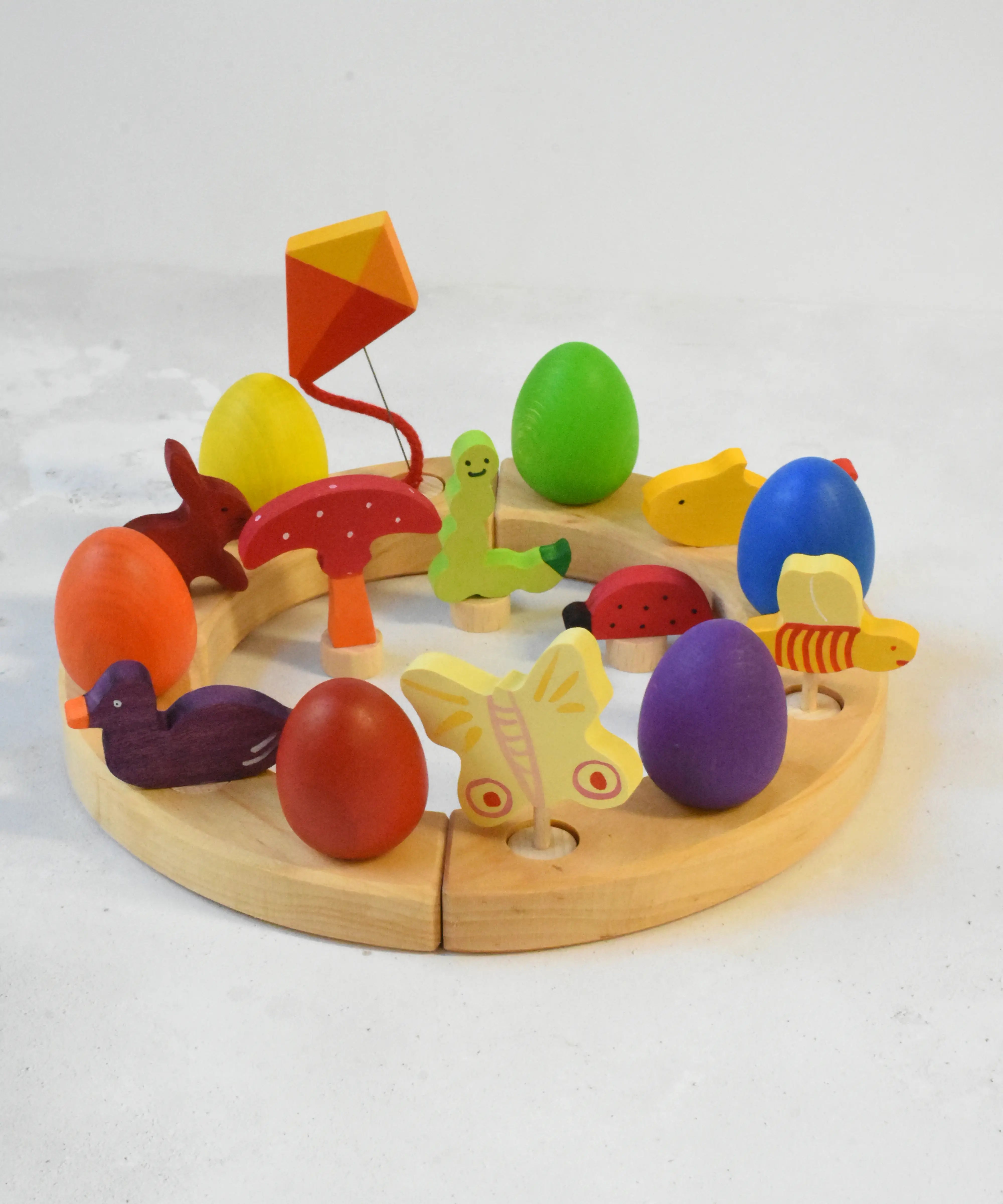 A Grimm's wooden celebration with a rabbit, kit, fish, bee, ladybird, butterfly worm , duck and mushroom decorative figures