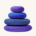 Grimms limited edition dream pebble set. 4 handcrafted wooden tactile pebbles in shades of blue and purple. Perfect for stacking and building