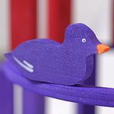 A close up of the Grimms wooden purple duck figure from the counting and story telling set available at Babipur showing the hand painted detail