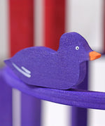 A close up of the Grimms wooden purple duck figure from the counting and story telling set available at Babipur showing the hand painted detail