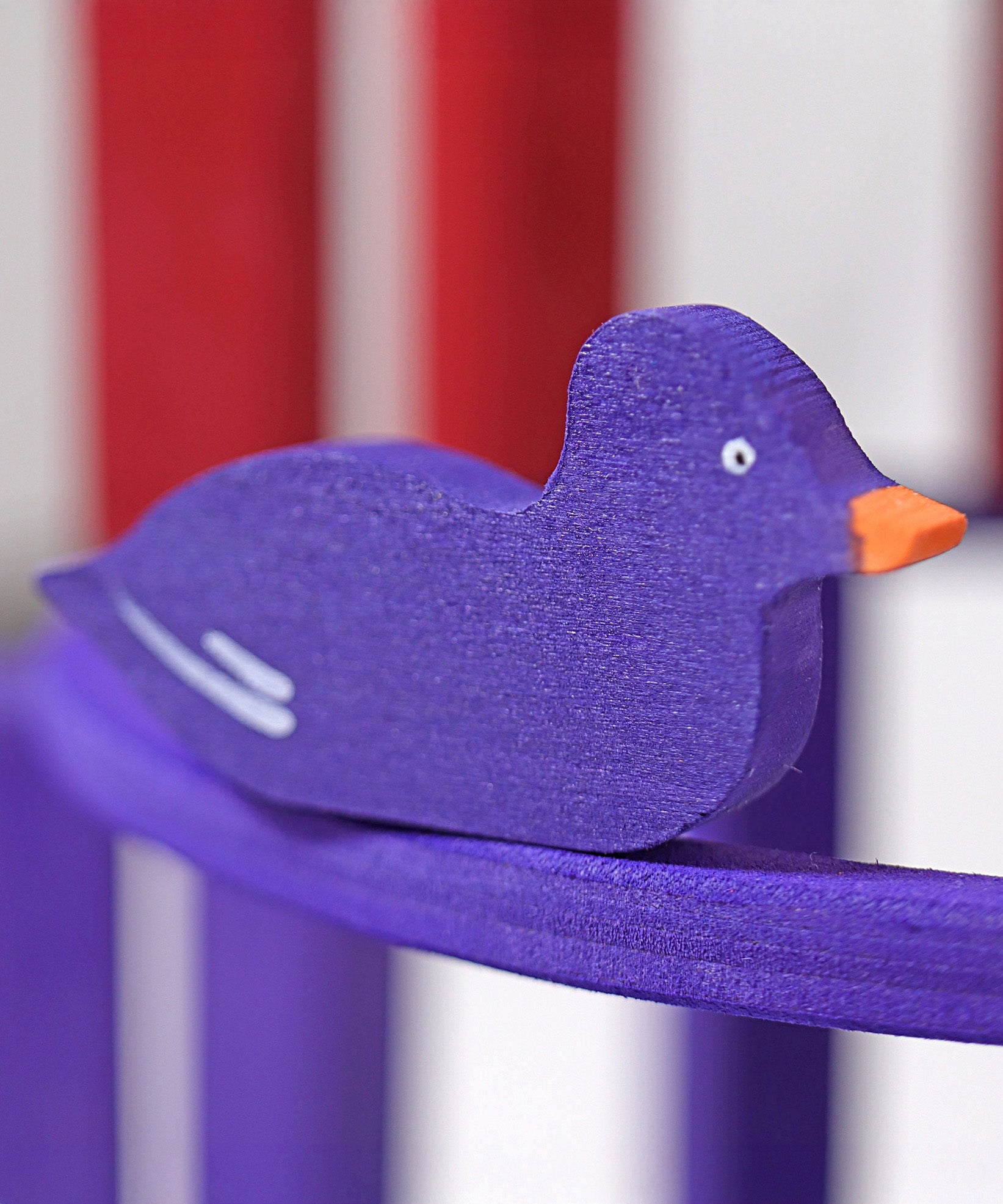 A close up of the Grimms wooden purple duck figure from the counting and story telling set available at Babipur showing the hand painted detail