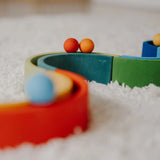 Close up of a Grimms small red and orange ball on a ball run