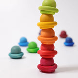 Stack of Grimms small wooden rainbow balls and rings