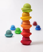 Stack of Grimms small wooden rainbow balls and rings