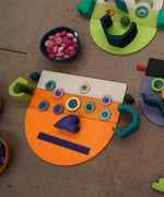 A abstract face made from Grimms wooden rainbow semi circle pieces and boards and other building blocks