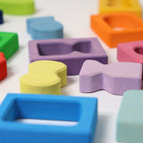 A close up of the window and shape blocks included in the Grimm's Windows Building Set wooden blocks in a wooden storage tray. These Grimm's wooden blocks are part of a wide range of wooden toys available here at Babipur. 