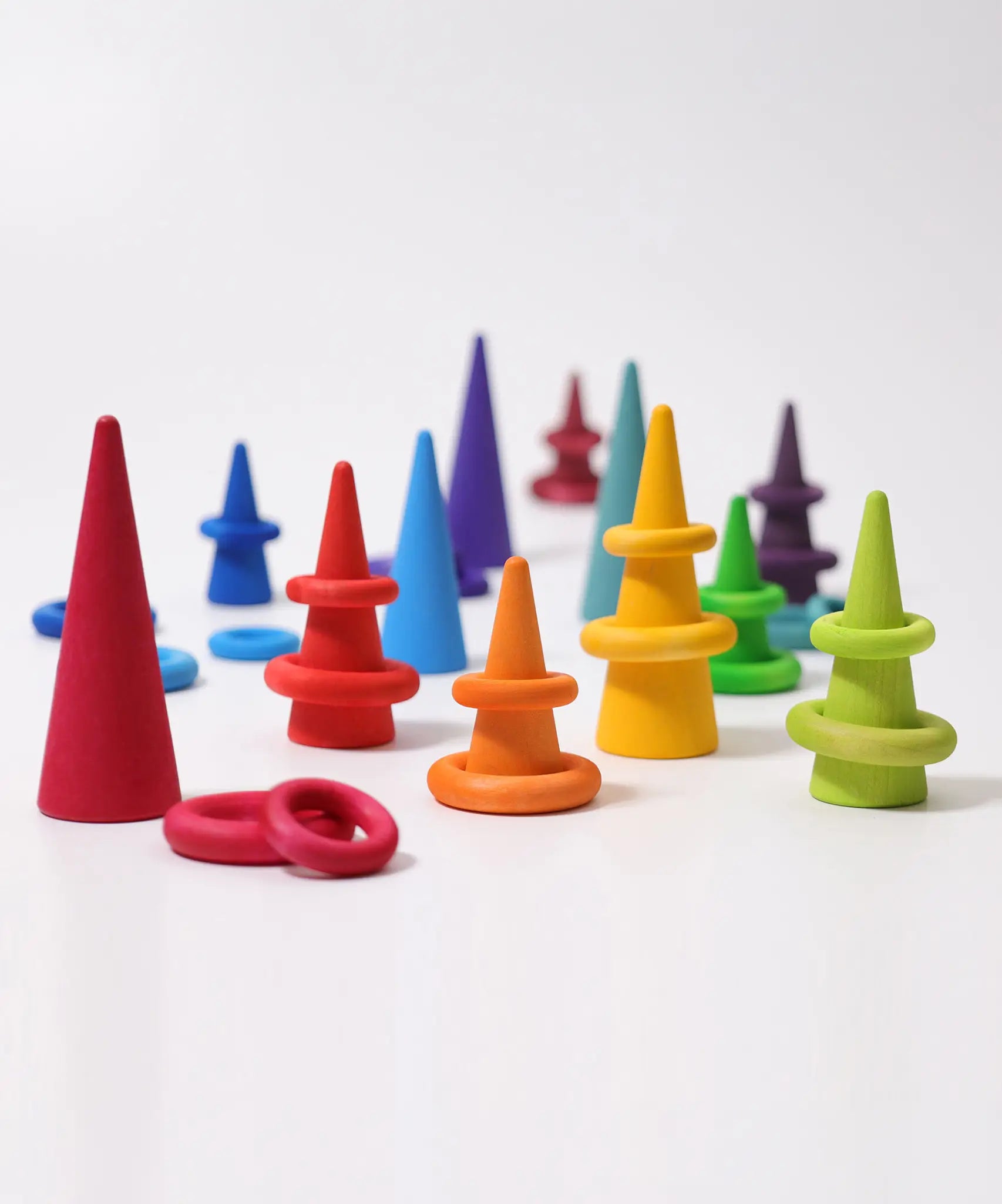 Grimms handcrafted wooden forest and building ring pieces in a rainbow palette. Made or sorting and small world play