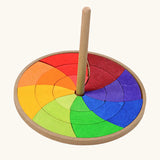 Grimms handcrafted wooden rainbow hand spinning top with loose pieces in bright colours to create new beautiful patterns 