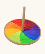 Grimms handcrafted wooden rainbow hand spinning top with loose pieces in bright colours to create new beautiful patterns 