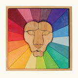 Grimm's rainbow lion wooden building blocks set in a wooden storage display tray.