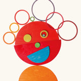 A playful face made from Grimms bright rainbow semi circle pieces