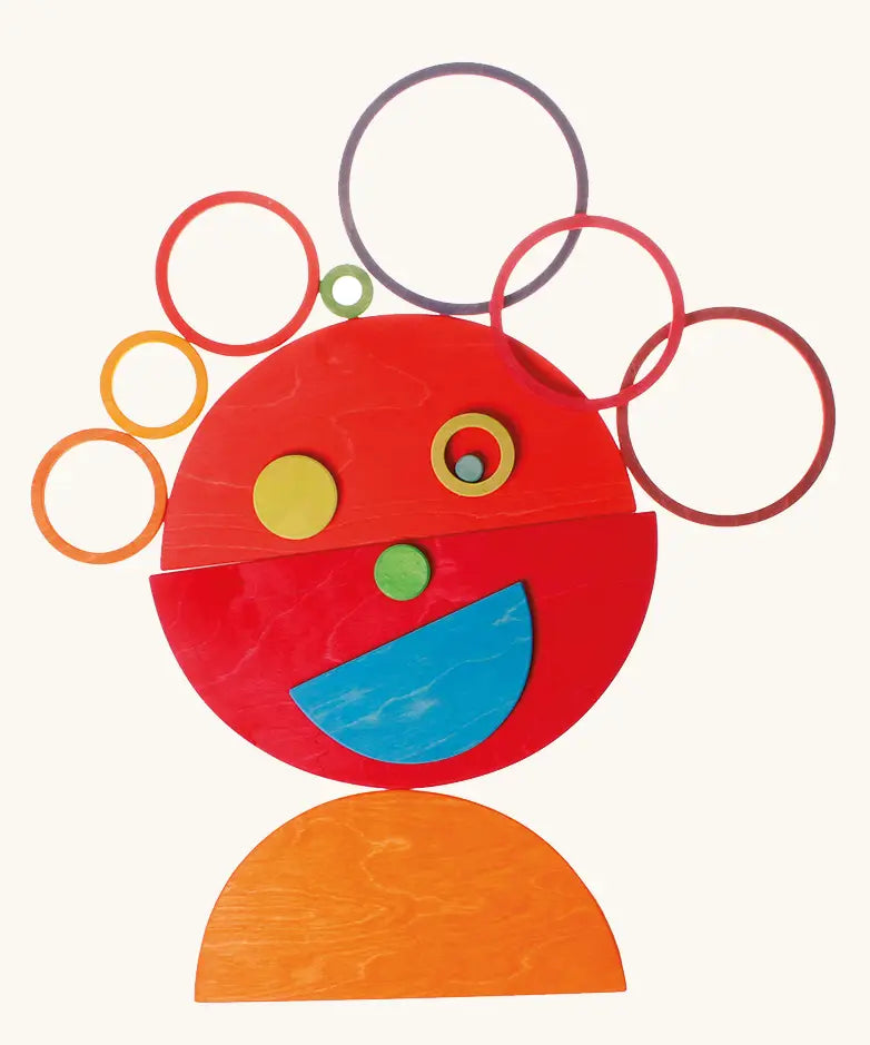 A playful face made from Grimms bright rainbow semi circle pieces