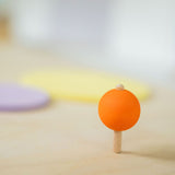 An orange coloured rainbow spinning top in motion. These Grimm's toys are part of a wide range of wooden toys available here at Babipur. 