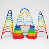 Multiple tower stacks made from Grimms wooden rainbow pieces including boards and semi circles
