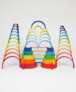 Multiple tower stacks made from Grimms wooden rainbow pieces including boards and semi circles