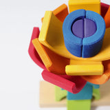 Overhead view of the Grimm's rainbow stacking tower. 2 7-piece rainbows on a stacking pole.