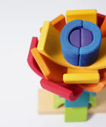 Overhead view of the Grimm's rainbow stacking tower. 2 7-piece rainbows on a stacking pole.