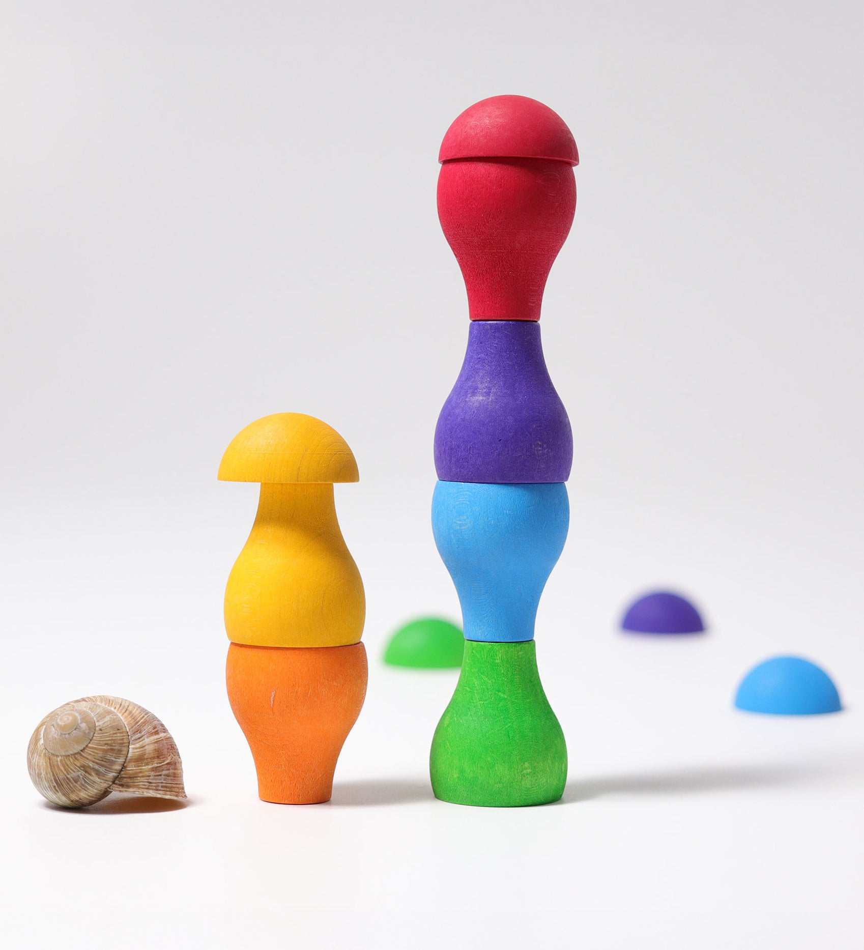 Grimm's Rainbow Mushrooms Sorting Game, the pieces have been stacked on top of each other to create little towers.