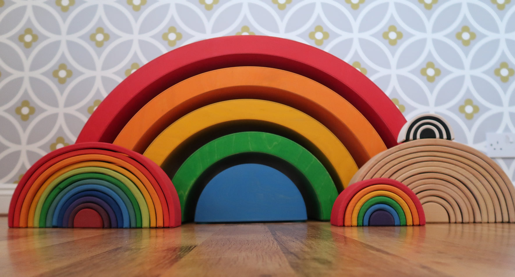 Grimm's Giant Rainbow with large, 6 piece and mini rainbows placed in front of them.