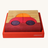 Grimm's red building set. A set of red, purple and natural wooden blocks that create a car shape when placed into the red coloured wooden storage tray that it comes with. These Grimm's toys are part of a wide range of wooden toys available here at Babipur. 