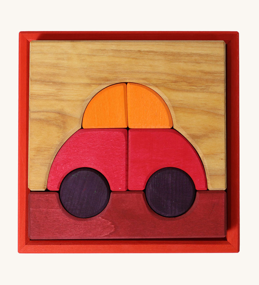 Grimm's red building set. A set of red, purple and natural wooden blocks that create a car shape when placed into the red coloured wooden storage tray that it comes with. These Grimm's toys are part of a wide range of wooden toys available here at Babipur. 