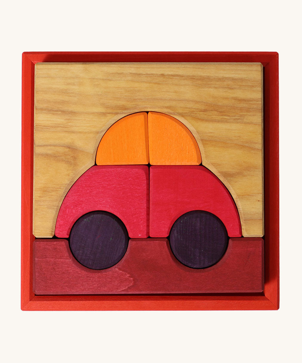 Grimm's red building set. A set of red, purple and natural wooden blocks that create a car shape when placed into the red coloured wooden storage tray that it comes with. These Grimm's toys are part of a wide range of wooden toys available here at Babipur. 