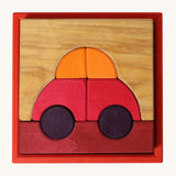 Grimm's red building set. A set of red, purple and natural wooden blocks that create a car shape when placed into the red coloured wooden storage tray that it comes with. These Grimm's toys are part of a wide range of wooden toys available here at Babipur. 