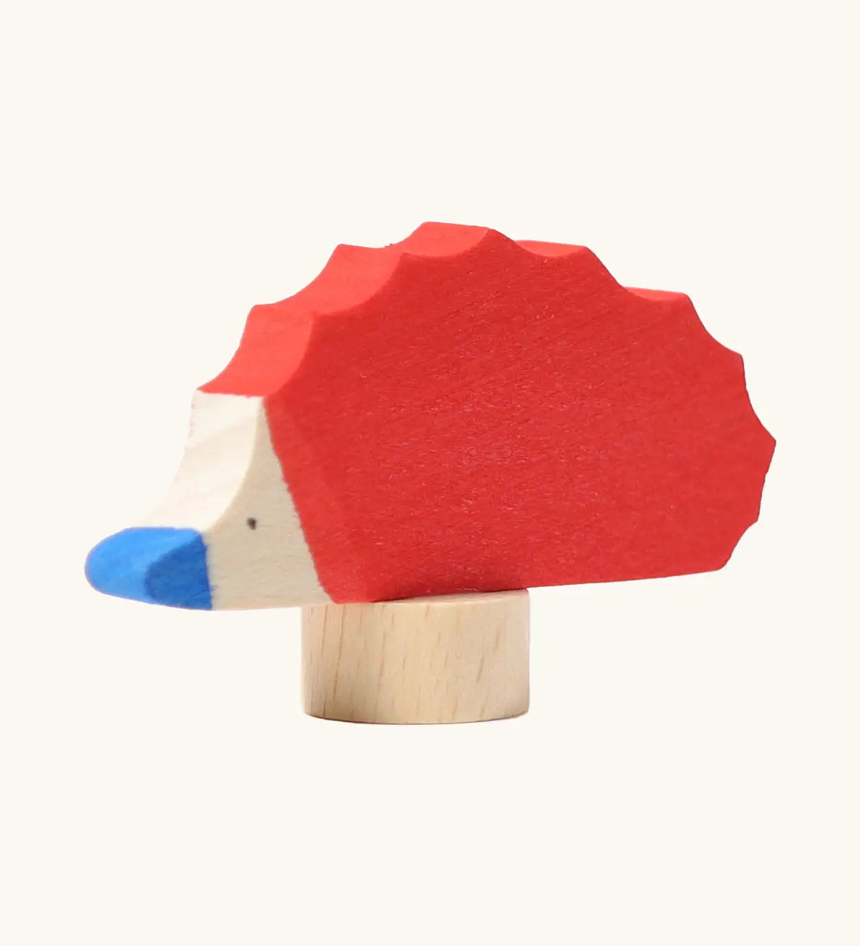 Front of Grimm's handcrafted wooden red hedgehog decorative figure showing hand painted blue nose and eyes
