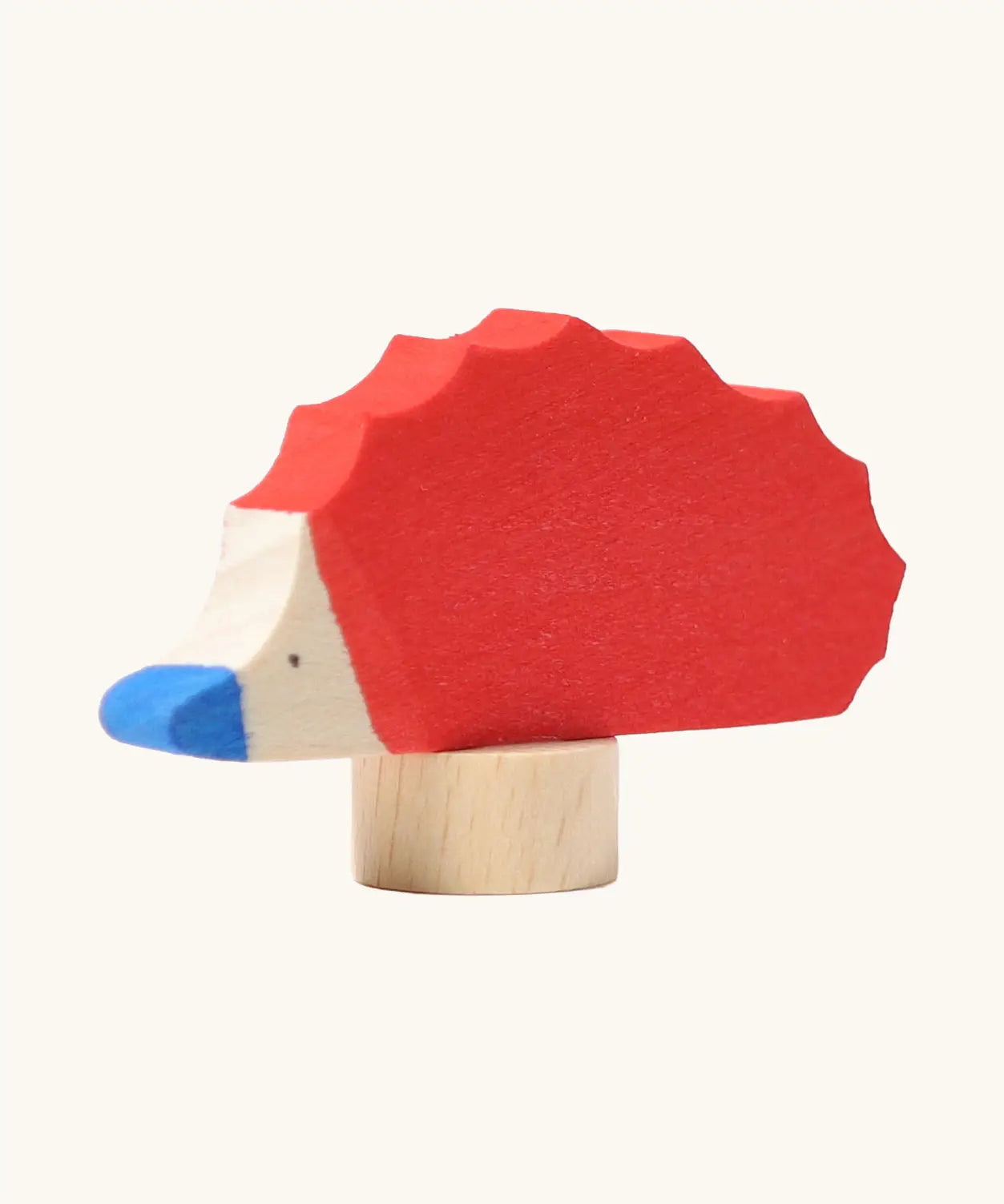 Front of Grimm's handcrafted wooden red hedgehog decorative figure showing hand painted blue nose and eyes