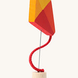 Grimm's Kite Decorative Figure, a red orange and yellow coloured kite to fit onto the Grimm's celebration ring. These Waldorf inspired decorative figures are part of a wide range of wooden decorations for celebration rings available here at Babipur. 