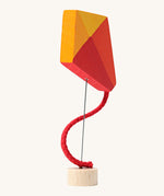 Grimm's Kite Decorative Figure, a red orange and yellow coloured kite to fit onto the Grimm's celebration ring. These Waldorf inspired decorative figures are part of a wide range of wooden decorations for celebration rings available here at Babipur. 