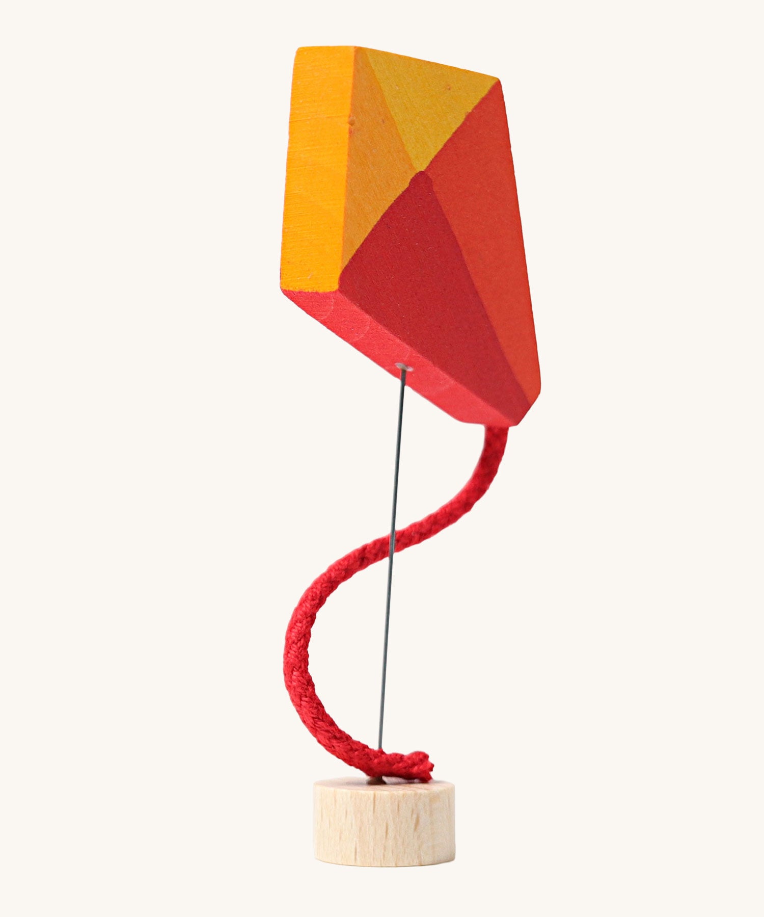 Grimm's Kite Decorative Figure, a red orange and yellow coloured kite to fit onto the Grimm's celebration ring. These Waldorf inspired decorative figures are part of a wide range of wooden decorations for celebration rings available here at Babipur. 