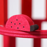 A close up of the Grimms wooden red ladybird figure from the counting and story telling set available at Babipur showing the hand painted detail