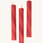 A set of 3 Grimms red marbled candles made from beeswax