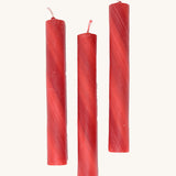 A set of 3 Grimms red marbled candles made from beeswax