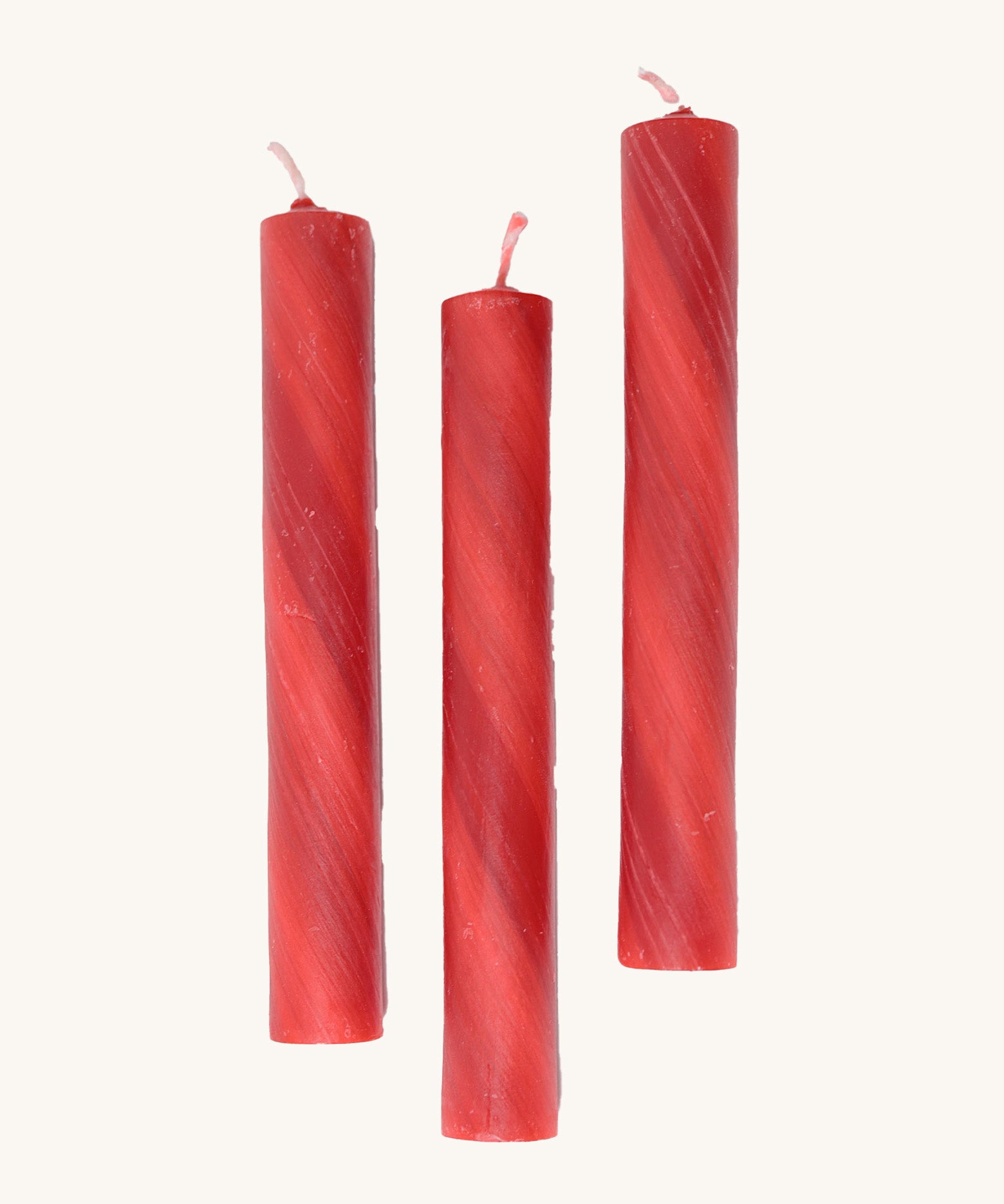 A set of 3 Grimms red marbled candles made from beeswax