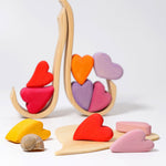 Grimm's Building Set Red Hearts shown with the hearts balanced on the frame pieces. 
