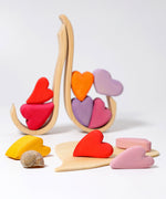 Grimm's Building Set Red Hearts shown with the hearts balanced on the frame pieces. 