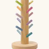 Grimms wooden sorting helper for rings with pastel dowels and a round natural base